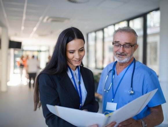 Doctor,And,Business,Woman,In,Hospital,Reading,Documents. Streamlining Hospital Operations: Key Strategies for Efficiency and Growth